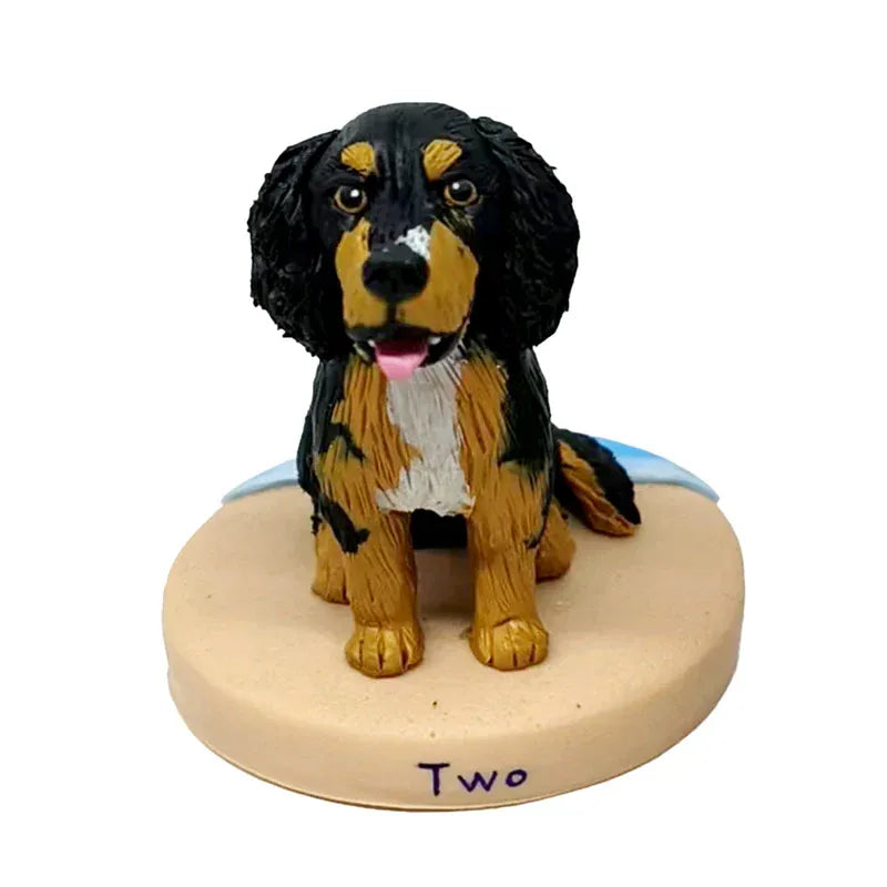 Dog bobblehead figurine on a heart-shaped base with 'Two' written on it, against a white background