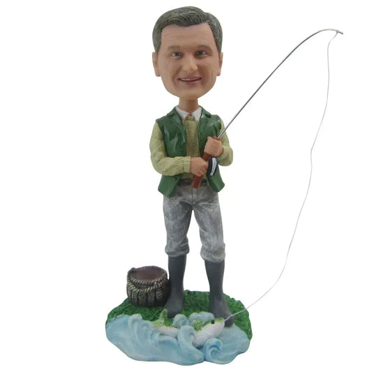 Bobblehead of a man fishing with a rod on a white background